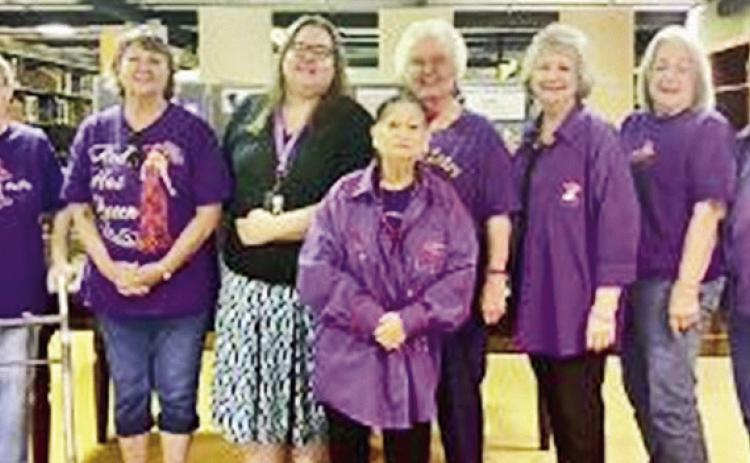The Natchitoches Red Hat Sisters visited Cammie Henry Hall at Watson Library last Tuesday. In front Liz Durr. L to R: Wanda St. Andre, Betty Whitehead, Donna Baker, Donna Masson, Mary Fosson, Joan Sheffield and Mary Jane Wright.