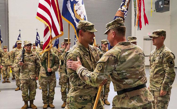 Maj. Gen. Thomas Friloux, the adjutant general of Louisiana, passes the organizational colors to Maj. Gregory O’Brien, the incoming commander of the 3rd Battalion, 156th Infantry Regiment, 256th Infantry Brigade Combat Team, during a change of command ceremony at Louisiana National Guard Training Center Pineville, August 18.