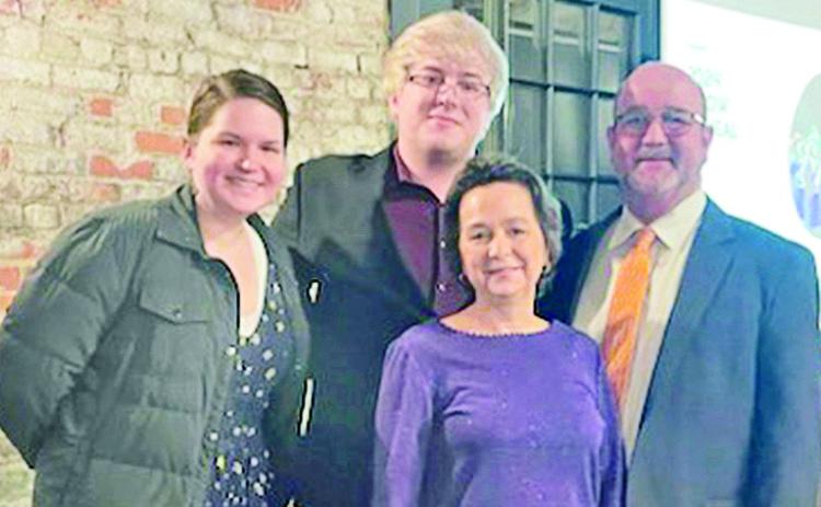Luke Niedens, center, is the inaugural recipient of the Richard and Shirley Jennings Scholarship. He is surrounded by Dr. Alexis Sczepanik, NSU horn professor, and Drs. Kristine Coreil and Jeff Mathews, who created the scholarship to honor the Jennings, their mentors and friends.