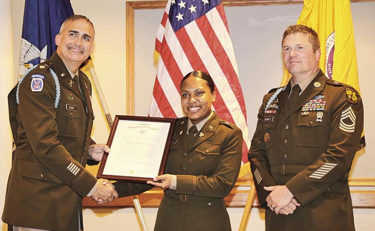2nd Lt. Arianna Astorga, center, received her U.S. Army commission certificate from LTC Joshua Drake, left, and MSG Michael Blakely, right.