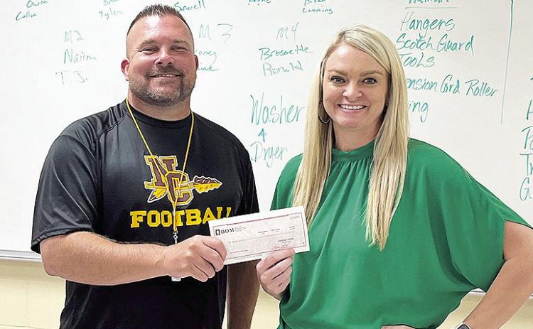 BOM was a table sponsor of the Meet the Chiefs football fundraiser. From left are Natchitoches Central High School Head Football Coach Jess Curtis and BOM’s Tiffany Woods.