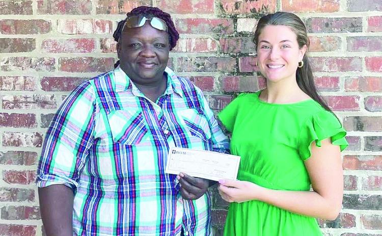 BOM made a donation to Monica Evans to help provide food for the elderly throughout the St. Maurice community during the holidays. From left are Evans and BOM’s Mary Scruggs.