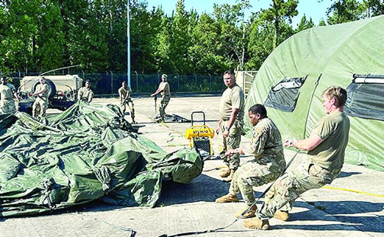 Soldiers from the Louisiana National Guard’s 205th Engineer Battalion prepare equipment that will be used during their deployment to staging sites in Florida ahead of Hurricane Milton’s imminent landfall.