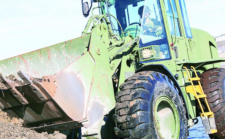 U.S. Army Sgt. Josie M. Perkins, 830th Engineer Detachment, 528th Engineer Battalion, 225th Engineer Brigade, assist with moving rocks and fill material to be used as safety barriers in Monroe, Louisiana, on January 10, 2023. The 101st ABN are in Louisiana conducting a JRTC rotation at Fort Johnson and needed a staging area for their equipment and refueling.