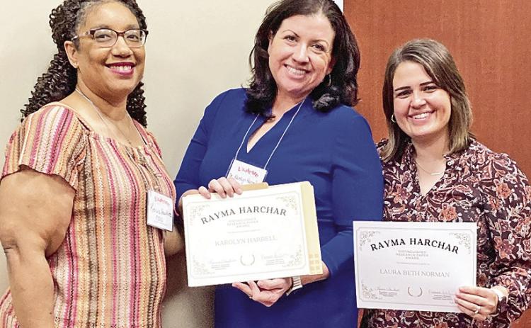 Dr. Keicia Hawkins, president of LERA’s executive board and NSU faculty, left, presented the Rayma Harchar Outstanding Research Paper Award to Dr. Karolyn Harrell. Dr. Laura Norman, professor of Adult Learning and Development at NSU, was Harrell’s research chair.