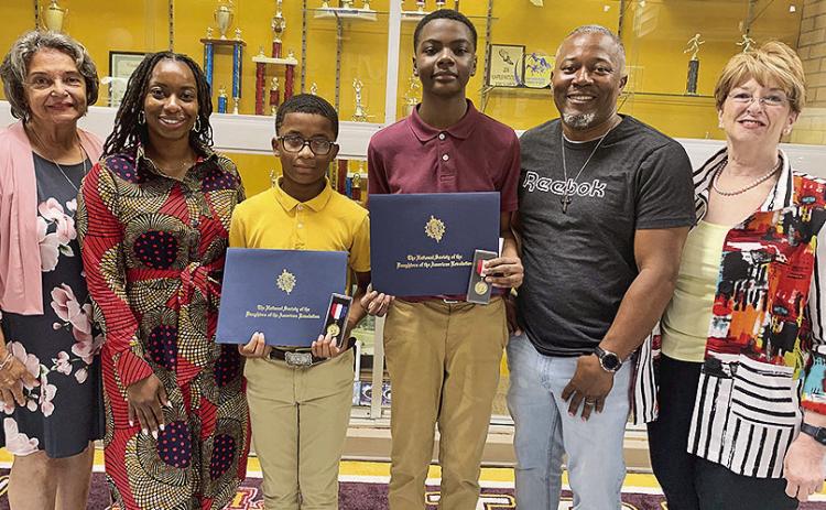 In May, The Cane River Chapter of the Daughters of the American Revolution recognized two Natchitoches Jr. High students by awarding them Youth Citizenship Medals for participating in a youth service group. They are seventh grader Jaylen LaCour and eighth grader Landon Holden who are members of Boys to Men at the junior high. From left are DAR chairman Frances (Lanie Sylvia), Principal Alexa Bernard-Conday, LaCour, Holden, Boys to Men sponsor Jermaine Thomas and DAR Regent Peggy Aycock.