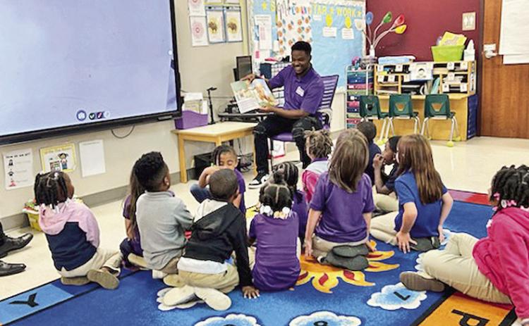 Kyle Scott and peers in the Call Me Mister program at NSU read to Fairview-Alpha Elementary students as service-learning project to support the Cradle to College initiative. Cradle To College provides literacy materials to children and their families.