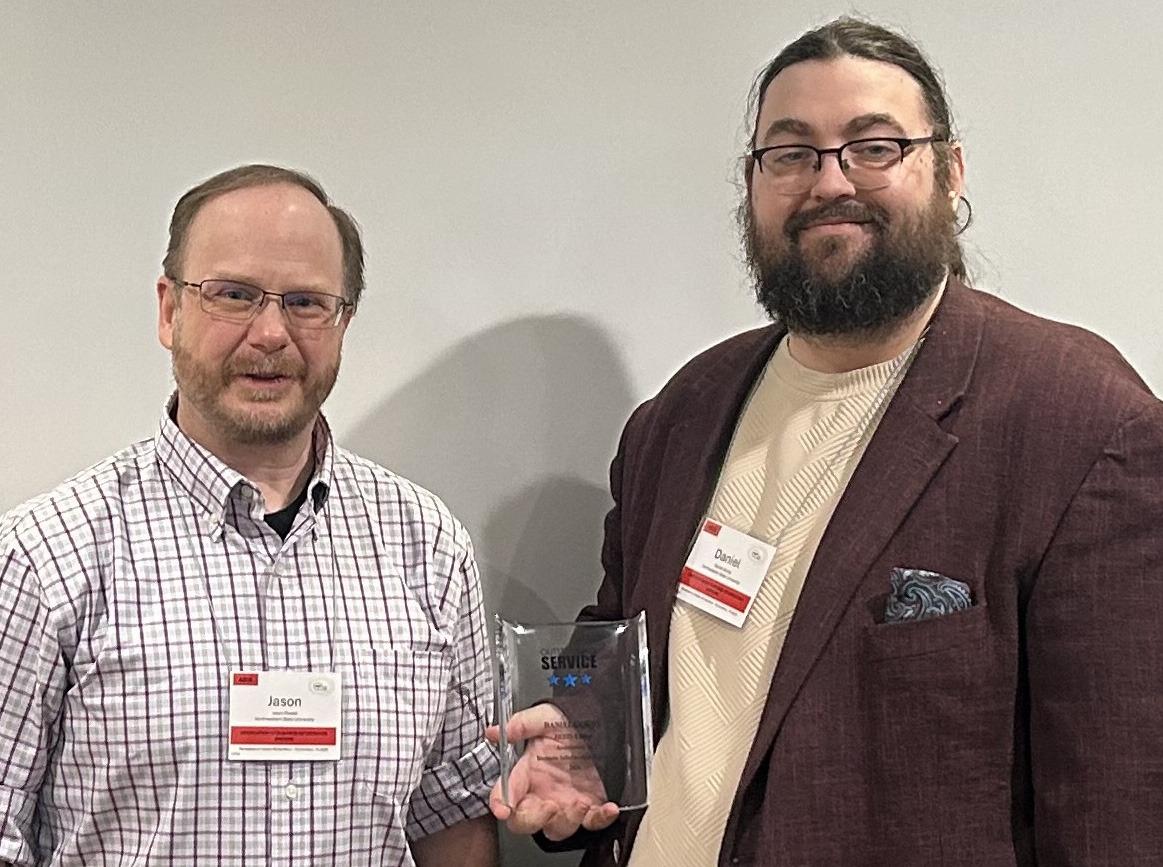 Dr. Daniel Gordy was recognized for outstanding service. At left is Assistant .Professor Jason Powell.