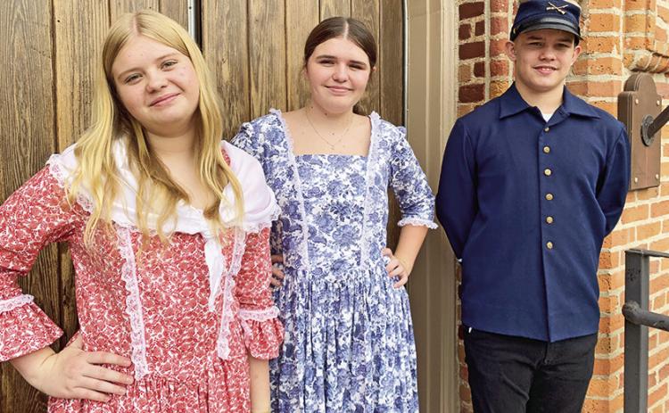 From left are Karyssa Griffith and Evie Nicholson as the Campbell sisters and Talon Roberts at Trinity Episcopal Church