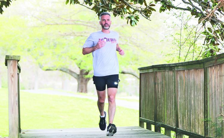 Dr. Damien Tristant runs along Chaplin’s Lake on the NSU campus.