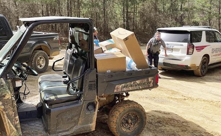 A delivery vehicle got stuck in the mud in western Natchitoches Parish following heavy rain March 15. A sheriff’s deputy and Provencal Police Chief Eric Upchurch rescued the driver and the vehicle.