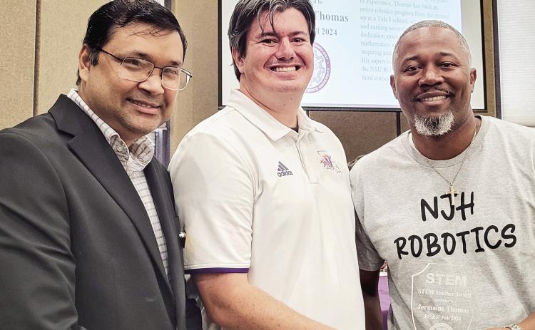 Jermaine Thomas, right, technology facilitator/coordinator at Natchitoches Junior High, was recognized with the STEM Teacher Award during NSU’s Robotics Competition Nov. 18. Congratulating Thomas were Dr. Shahriar Hossain, left, head of the Department of Engineering Technology and Dr. Chris Lyles, director of NSU’s School of STEM. See Story Page 2A.