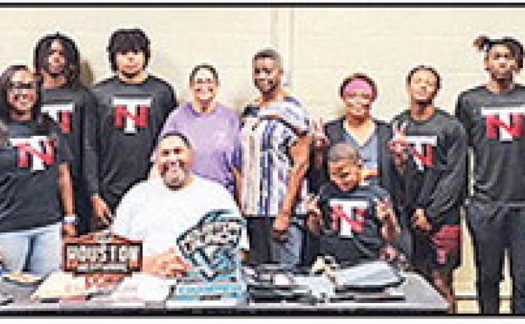 Victor Pinckney. right, coaches the Natural Talent travel basketball team that received funding from the Foundation.