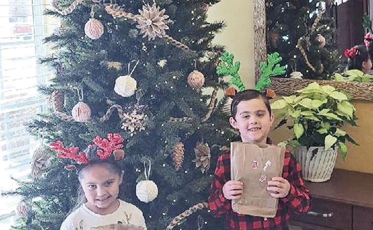 Xzaven and Zinnia Colwell, ages 8 and 5, were among the St. Mary’s students who delivered holiday cheer to residents at The Community Care Center. In addition to handing out gifts and cards, Xzaven, played four Christmas songs on the piano along with five other students of piano teacher Ashley Shoemaker.