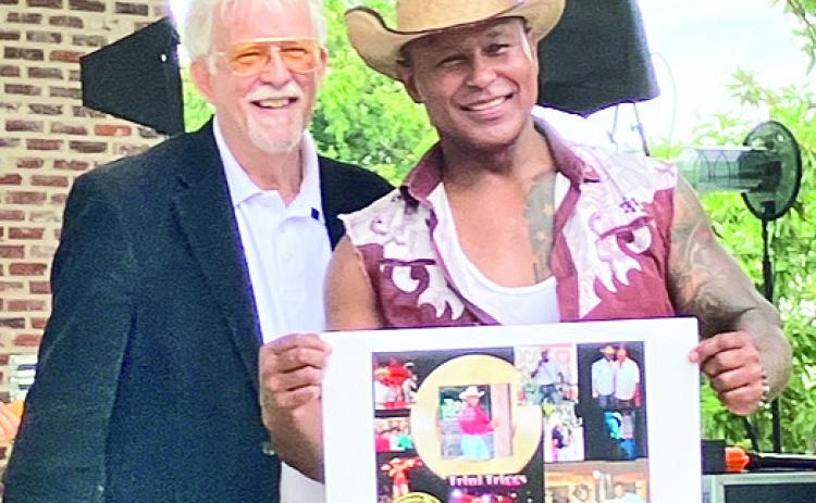 Natchitoches’ own Trini Triggs is inducted into the Louisiana Music Hall of Fame. Pictured from left are Mike Shepherd of LMHF and Triggs.