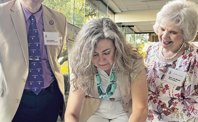 Jacob Ruppert and Symphony Society President Mary Lou Brown welcomed Dosia McKay, center, who composed “Earthrise,” played as a world premier Tuesday evening by the symphony orchestra under the direction of Music Director Doug Bakenhus.