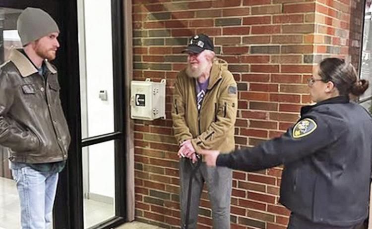 Sheriff Stuart Wright commends a deputy and resident John Cunningham for helping a senior citizen they spotted at a business on Interstate 49 who had fallen when the temperature was in the 30s. The deputy returned the next day for a wellness check and found the man okay.