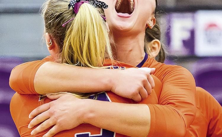NSU’s Jade Longlad hugs teammate Gillian Grace Wolf (5) after Wolf’s game winning kill Saturday against LSU New Orleans. Photo by Chris Reich - NSU Photographic Services