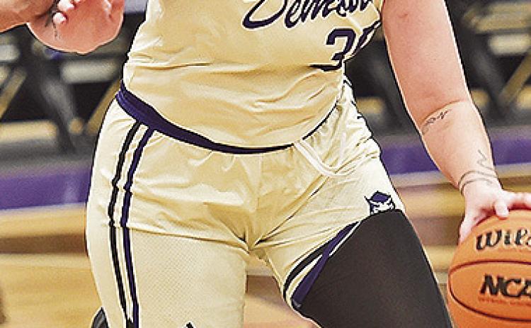 Sharna Ayre drives in for a basket against Arkansas Baptist. Photo by Gary Hardamon