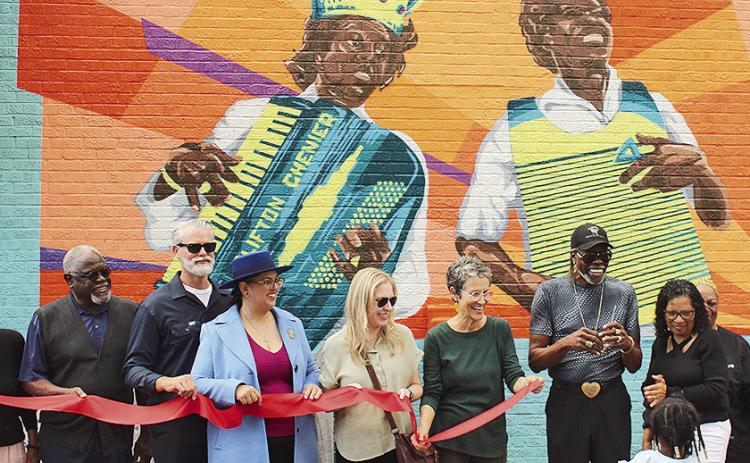 Ribbon cutting for a new mural titled, ‘At Sunset,’ at The Funky Flea in the Sunset Cultural District in Sunset,by artists Liz and Jed Cornett. (Image credit: Louisiana Office of Cultural Development)