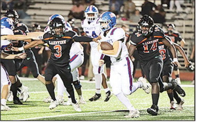 St. Mary’s John Paul Thibodaux breaks free for a touchdown run against Lakeview on Friday night, helping lead the Tigers to a 58–0 victory and a spot in the playoffs.