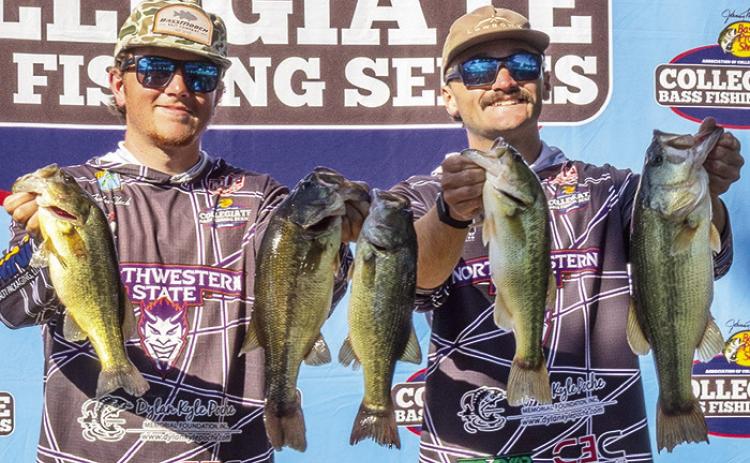 Northwestern State University Fishing Team members Ayden Slack, left, and Daniel Gallagher display their catch at the AFTCO Collegiate Bass Open on Lake Dardanelle in Russellville, Ark.
