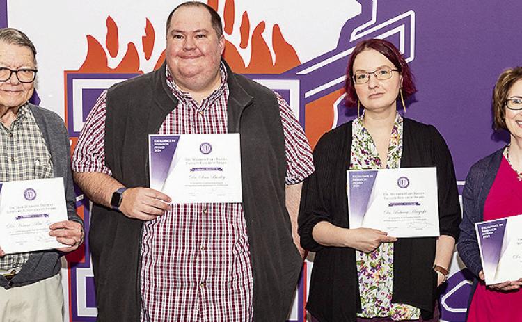 Four members of the Northwestern State University were presented with Faculty Research Awards in recognition of scholarly research endeavors. From left are Dr. Hiram “Pete” Gregory, Dr. Sean Bartley, Dr. Rebecca Macijeski and Dr. Michelle Fazio-Brunson.