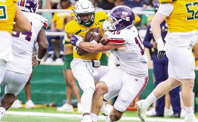 Northwestern State’s Barrett Newman (15) tackles Southeastern Louisiana quarterback Kyle Lowe during Saturday’s game. Photo by Chris Reich/NSU Photographic Services