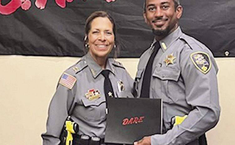 Capt. Wendy Llorens congratulated the most recent graduate of the DARE training, Dep.Adrian Duruisseau.