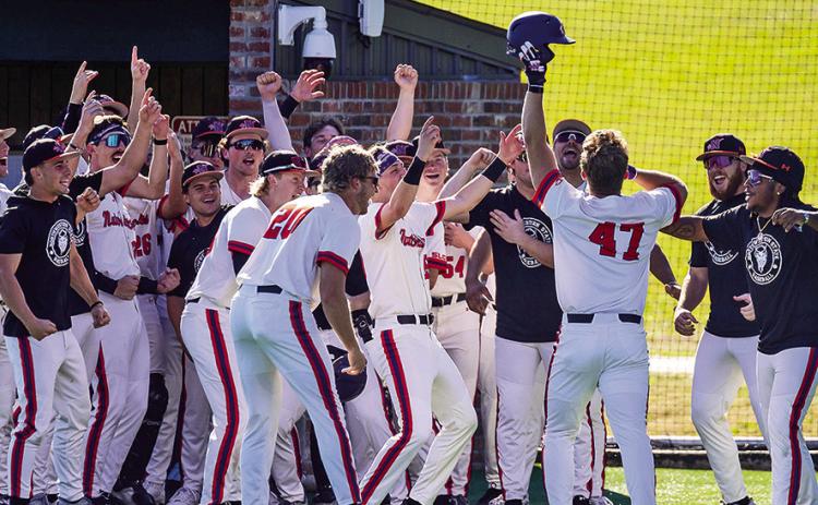 Northwestern State’s team celebrates Colton Harrison’s go-ahead, tworun home run Sunday. Photo by Chris Reich/NSU Photographic Services.