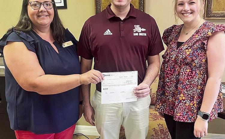 BOM Financial Services support the NCHS Pride of the Tribe Marching Band. The funds will help with replacing uniforms and the band’s rehearsal tower. The band participates in football games, local parades, marching band festivals, concert band festivals and concert band exhibitions. Pictured are BOMFS’ Reba Phelps, NCHS Band Director Cody Thurber and NCHS’ Emmaleigh Toney.