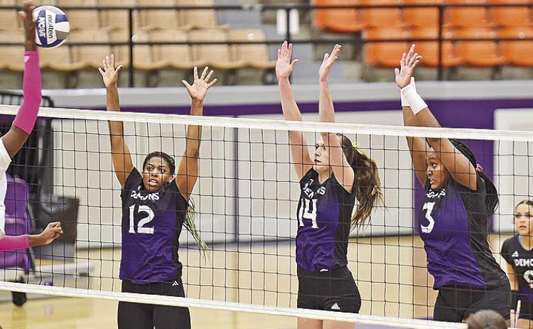 Pictured from the left are Symone Wesley, Reaghan Thompson and Breanna Burrell leap for a block attempt against UIW. Photo by Gary Hardamon