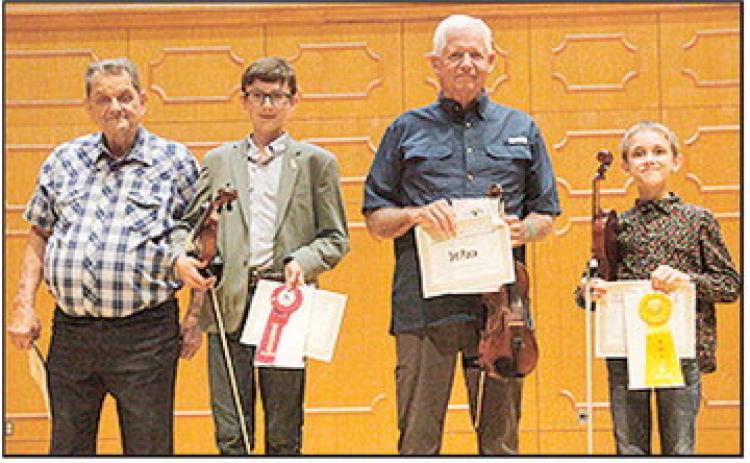 The annual Louisiana State Fiddle Championship was held in Magale Recital Hall on the campus at Northwestern State University as part of the 45th Annual Natchitoches-NSU Folk Festival. The winners were, left to right, 2025 Louisiana State Fiddle Champion Ron Yule of DeRidder, second place Samuel O’Kelley of DeRidder, third place Phillip Mayo of Leesville and fourth place Asher Hotard of Folsom. Photo by Peter Jones