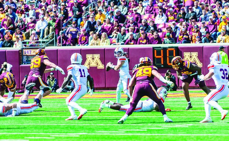 Northwestern State quarterback Abram Johnston (center) throws a pass during the Demons’ loss to Minnesota. Photo by Brad Welborn/ NSU Sports Information