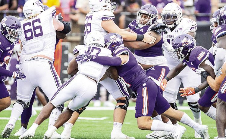 Jared Pedraza (right) makes a tackle on SFA’s Jerrell Wimbley during a Sept. 16 game in Natchitoches. Photo by Chris Reich/NSU Photographic Services