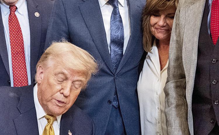 U.S. Sen Bill Cassidy looks on as President Donald Trump signs the HALT Fentanyl Act.