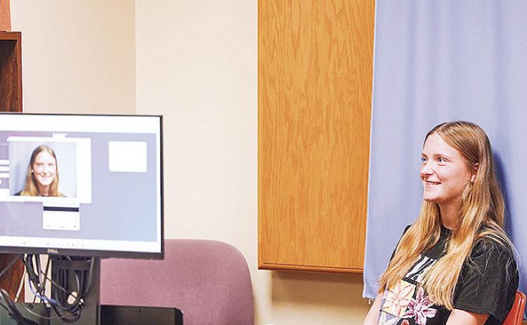 Incoming Northwestern State University student Addison Berg poses for her student identification card photo during registration at NSU's Shreveport campus.