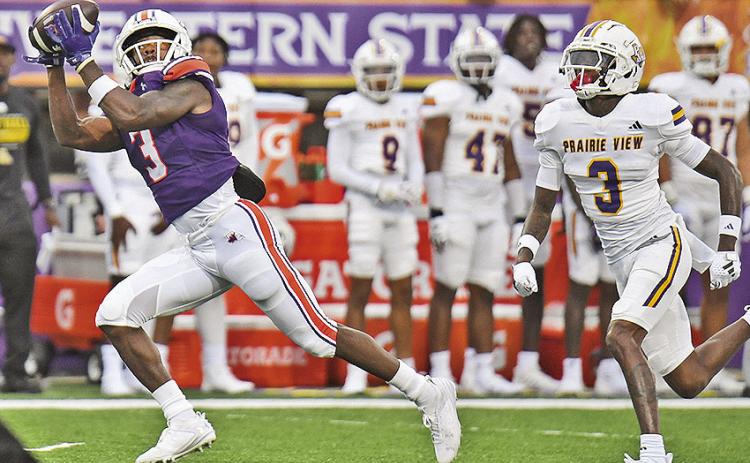 Myles Kitt-Denton (left) pulls in a 71-yard touchdown catch against Prairie View A&amp;M on Sept. 7. Photo by Chris Reich/NSU Photographic Services