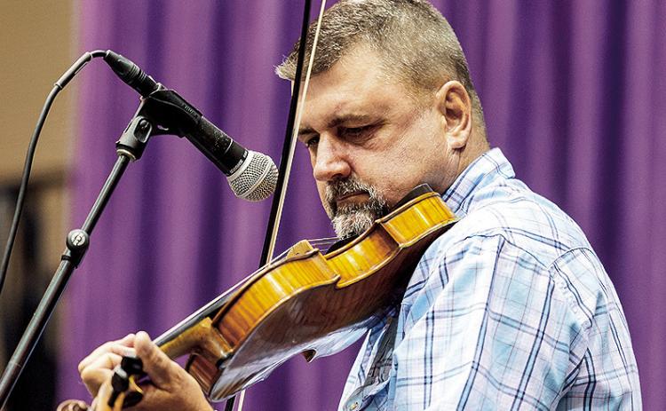 Last year’s champion Curry Perkins of Ragley trades his fiddle for a score card to judge this year’s competition held at 1 p.m. in Magale Recital Hall.