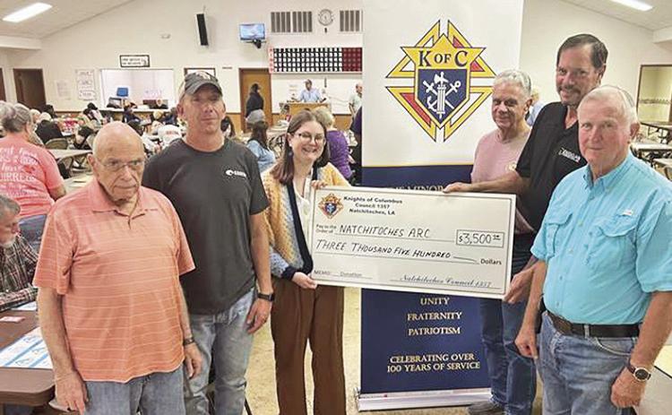 Natchitoches Knights of Columbus presented $3,500 to the Natchitoches Adult Disabilities Services (N.A.R.C.) organization. For over 30 years, Natchitoches Knights has made an annual donation to support the non -profit N.A.R.C. From left are Ed Giering and Chad Deranger, KC members, Jessie Clark, representing N.A.R.C., Don Mims, KC member, Ted Duggan, Grand Knight of Natchitoches KC, and Robert Scott, KC member.