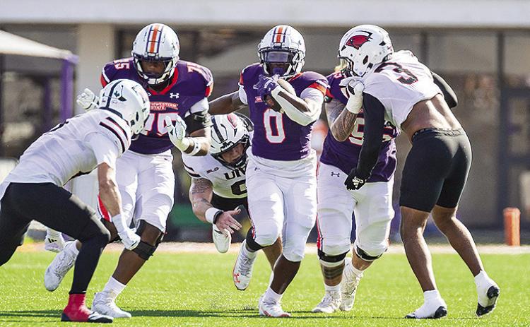 Myion Hicks (0-purple) plows ahead against the UIW defense. Photo by Chris Reich, NSU Photographic Services
