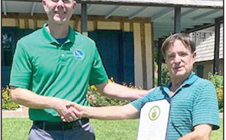 The National Weather Services recognized Wiley Butler for his 30 years as a local weather observer. From left are manager in charge of operations Brad Bryant and Butler.
