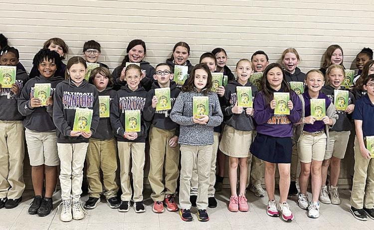 Mike Newton, Tommy Caldwell and Joe Henry provide 4th graders The Lightning Thief books at Provencal Elementary.