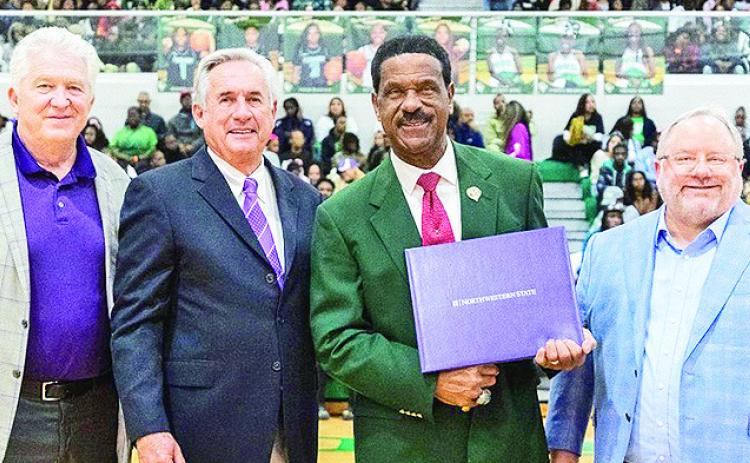Peabody Magnet boys basketball coach and math teacher Charles Smith (holding award) was joined by, from left, retired Northwestern State basketball coach Mike McConathy, NSU president James T. “Jimmy” Genovese and Louisiana Sports Hall of Fame chairman Doug Ireland at a pregame ceremony Jan. 3 when Genovese presented Smith with the university’s prestigious Nth Degree.