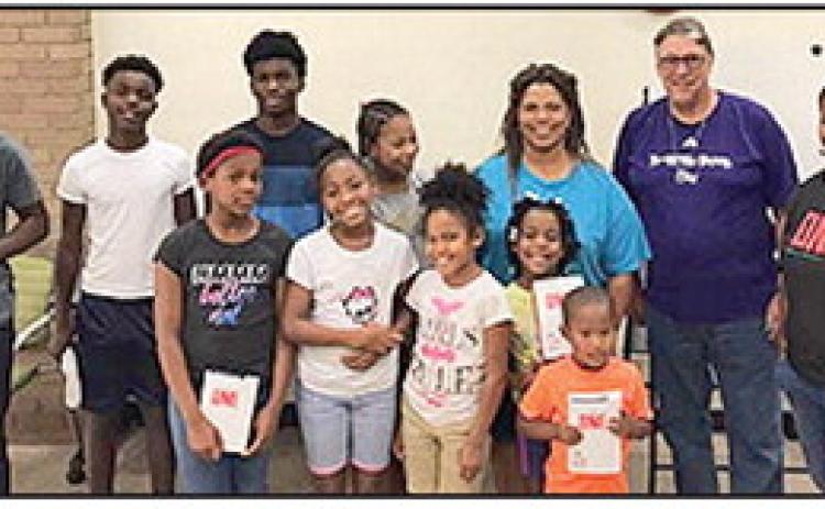 Evangelist Bonita Moses Arnold is pictured with local FCA in Natchitoches Parish Library on 450 second street, as a sponsor.